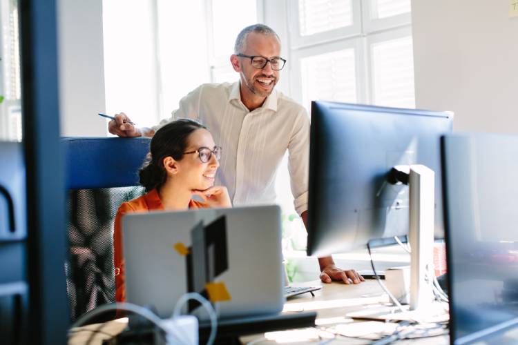 2 people in front of computer monitor